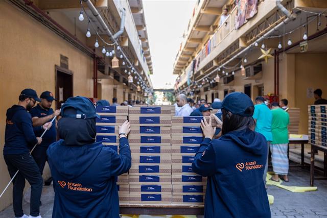 Volunteers stack boxes of food for community distribution